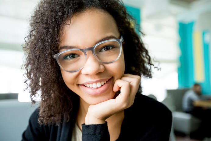 Curly haired woman wearing her glasses