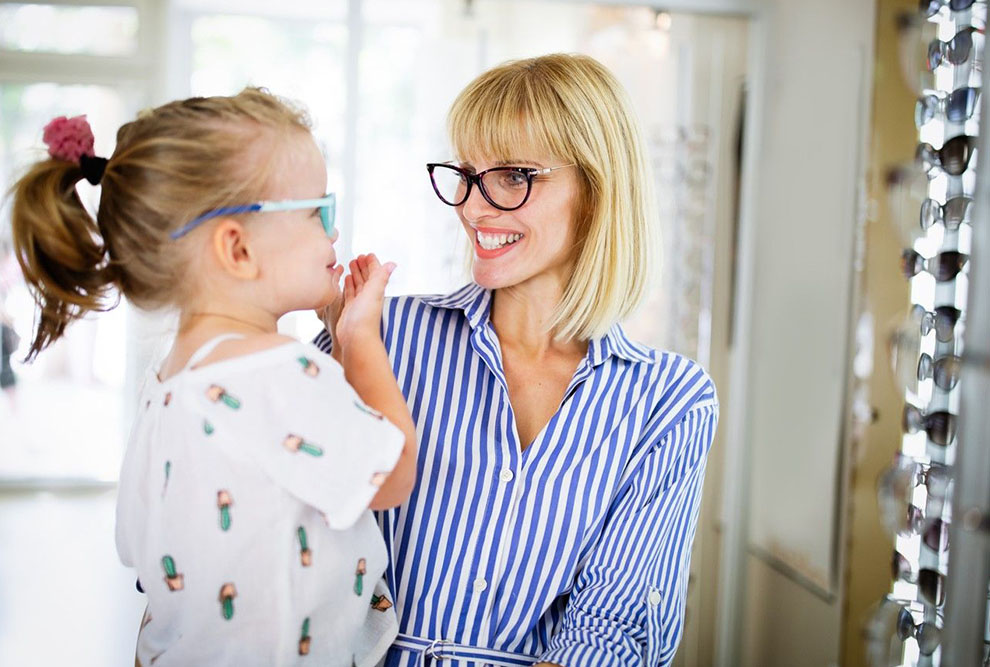Mother and daughter eyeglasses fitting