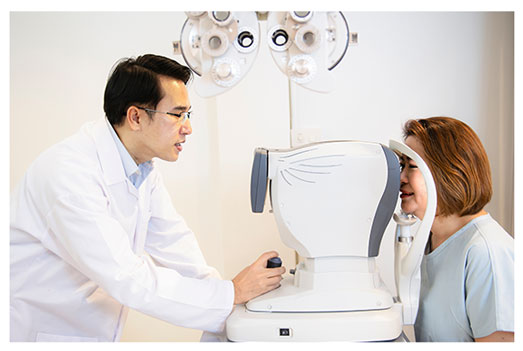 Doctor performing an eye exam to female patient