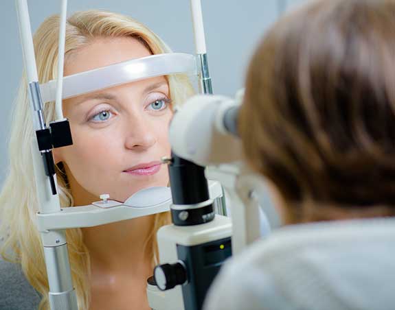 Woman getting an eye exam in Fountain Valley