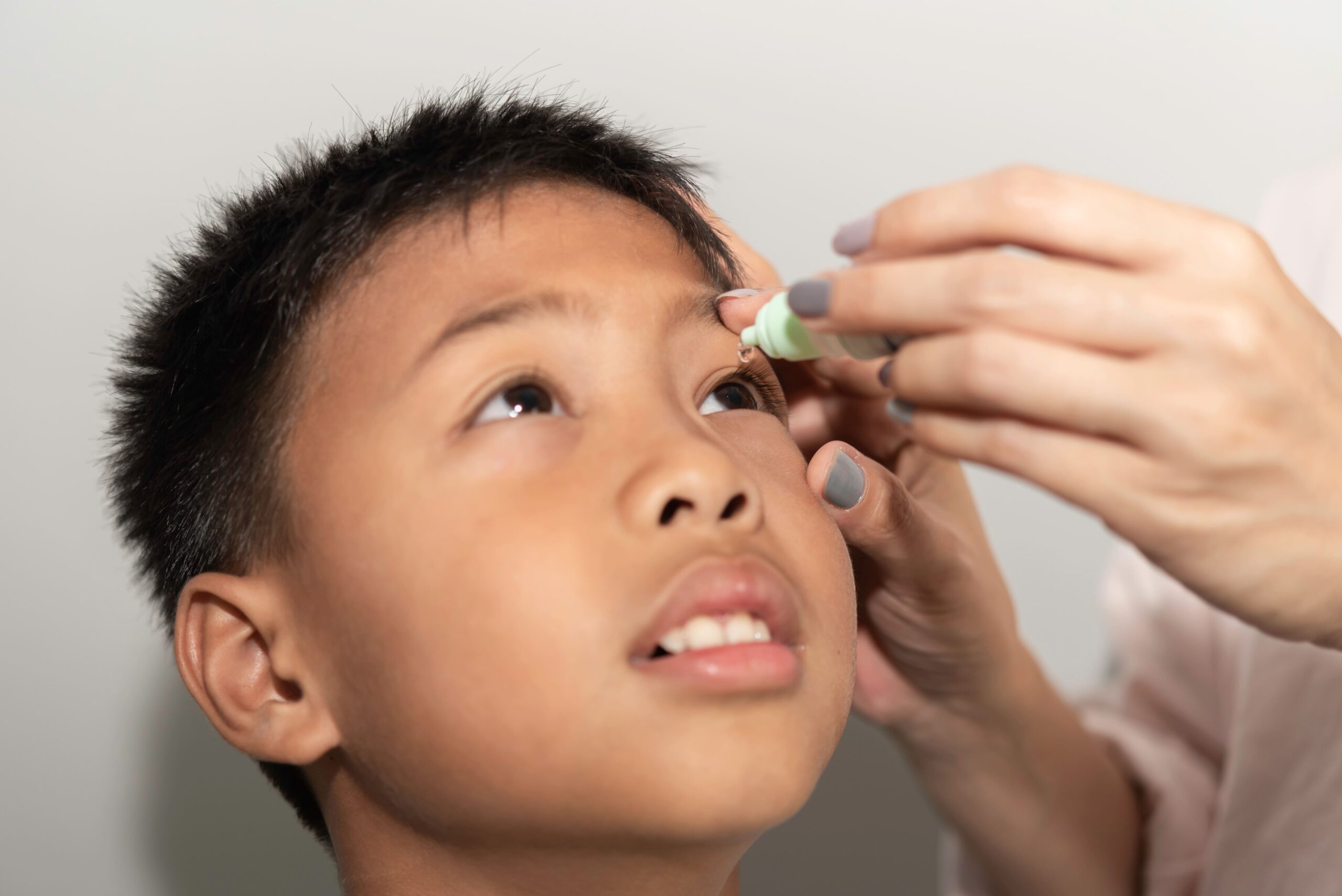 boy-taking-eye-drops